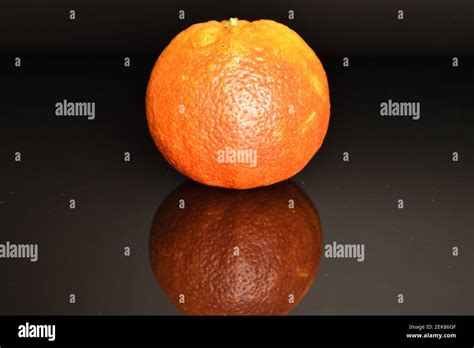 One Ripe Juicy Fresh Red Sicilian Orange On A Black Background Stock