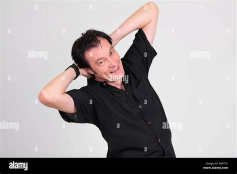 Happy Mature Handsome Man Smiling Against White Background Stock Photo Alamy