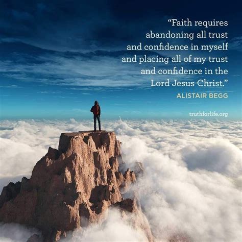 A Man Standing On Top Of A Mountain Above The Clouds With A Bible Verse