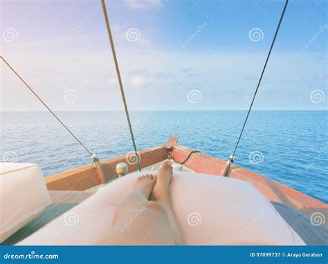 Private Boat Trip On Open Sea Image Shows Legs Of A Woman Lying On A