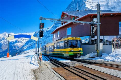 Yellow Swiss Train in the Railway from Interlaken To Jungfraujoch ...