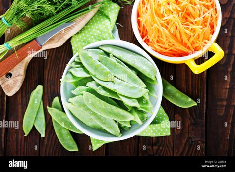 Green Peas In Bowl And On A Table Stock Photo Alamy