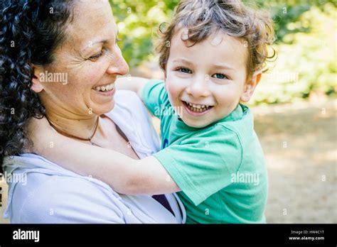 Caucasian Mother Carrying Smiling Son Stock Photo Alamy