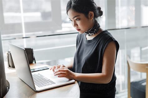 "Woman Working On Her Laptop" by Stocksy Contributor "Lumina" - Stocksy