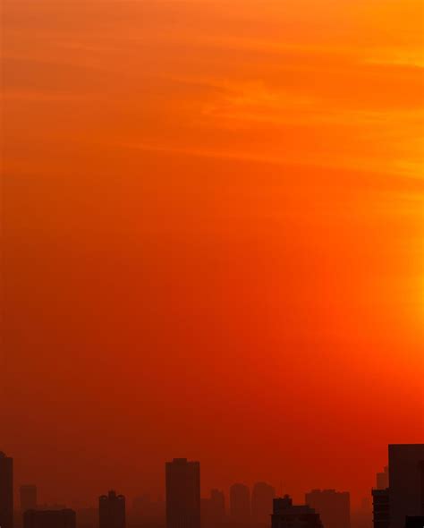 City In The Morning With Red Sunrise Sky And Smog Air Pollution