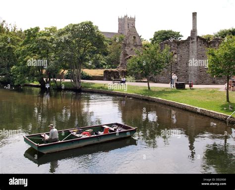 Man Fishing From A Boat On The River Christchurch Dorset Uk 2013