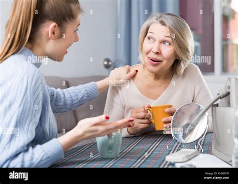 Mature Mom Talks To Adult Daughter At The Table Tea Party Stock Photo Alamy