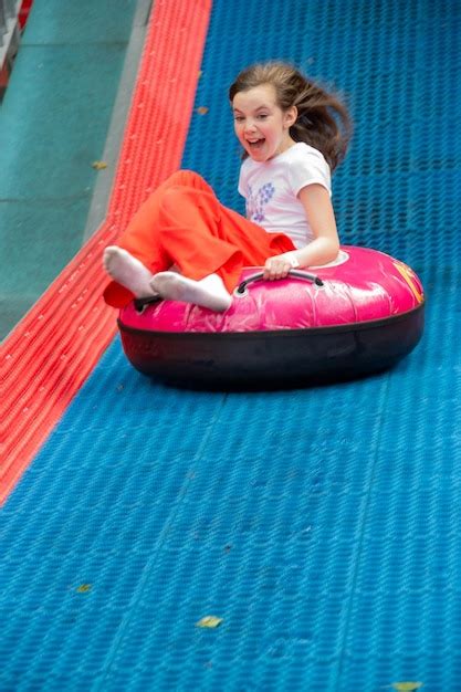 Premium Photo A Girl Is Sitting On A Pink Inner Tube