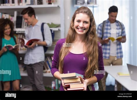 Student Carrying Small Pile Of Books Stock Photo Alamy