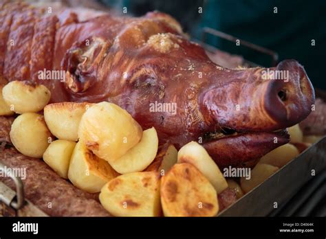 Hog Roast Pigs Head And Roast Potatoes Stock Photo Alamy