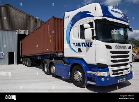 An Articulated Lorry With A 40 Ft Shipping Container At A Loading Point