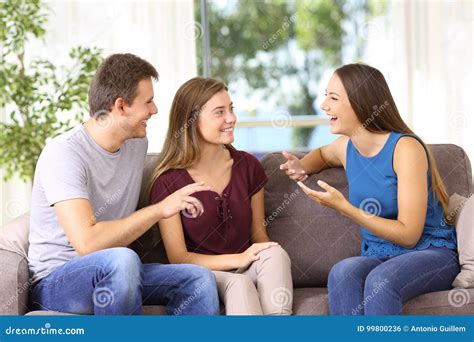 Three Joyful Friends Talking On A Couch At Home Stock Photo Image Of