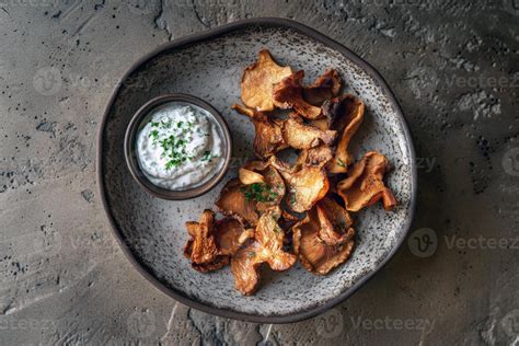 gourmet chanterelle mushroom chips  creamy herb dip  rustic plate