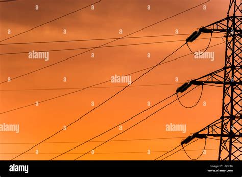 Silhouette Of The Evening Electricity Transmission Pylon At Sunset