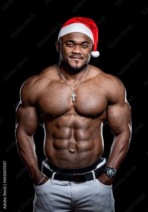 Very Muscular Afro American Man With Naked Torso Poses On Black