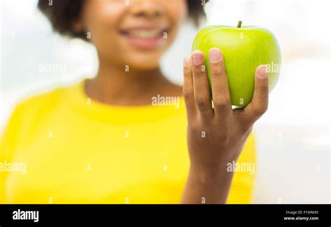 Happy African American Woman With Green Apple Stock Photo Alamy