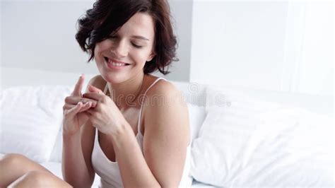 Body Skin Care Woman Applying Body Cream On Leg Skin At Bedroom Stock