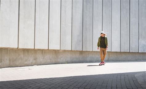 Premium Photo Adult Man Riding On Skateboard Near Concrete Wall