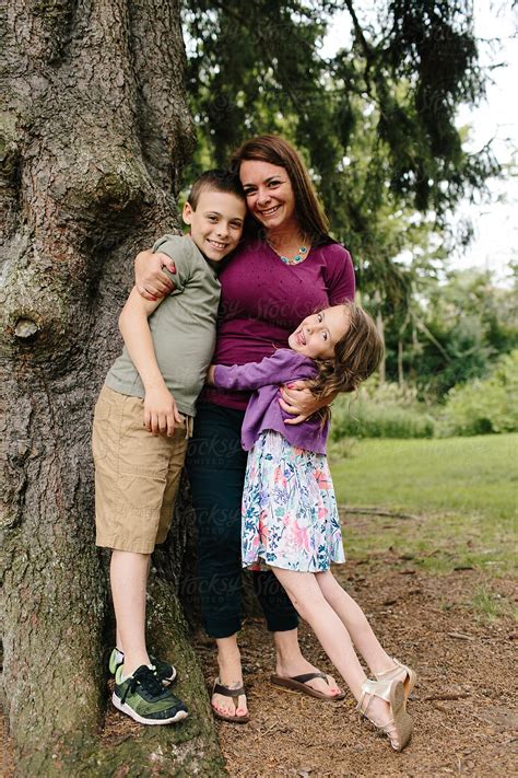 Mother Son And Daughter Smiling And Hugging By Stocksy Contributor