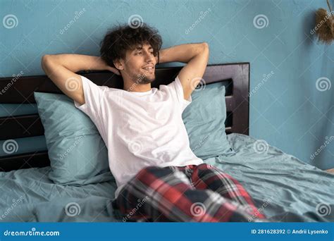 Calm Minded Young Man 20s Wearing Pajamas Lying In Bed Sleep Slumber