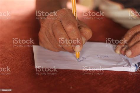 Closeup Hands Of An Old Man Writing Down And Drawing A Route On White