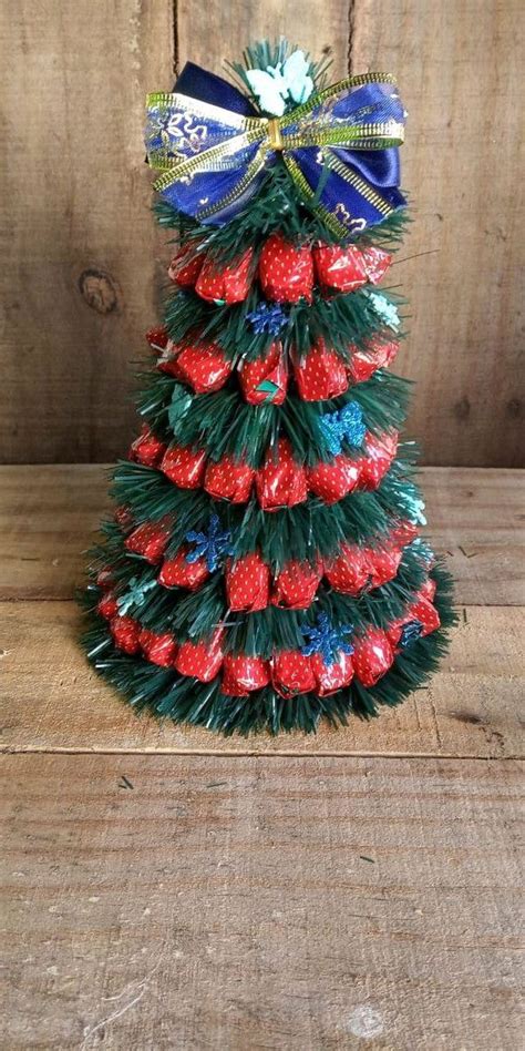 A Christmas Tree Made Out Of Strawberries With Blue Ribbon And Bow On