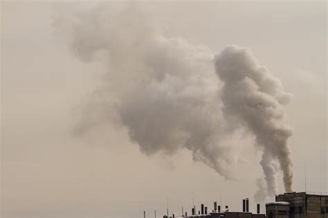 Premium Photo Smoke Emitting From Chimney Against Sky