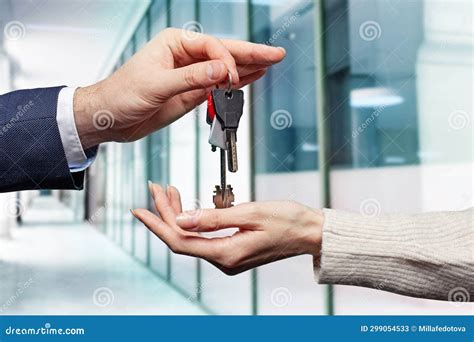 Real Estate Concept Estate Agent Giving House Keys Against Abstract