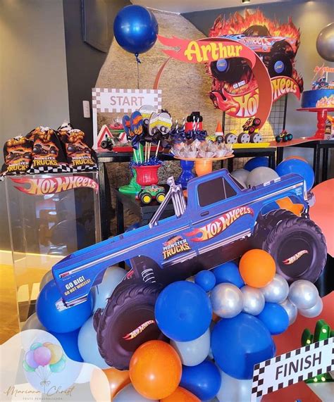 An Assortment Of Balloons And Decorations For A Monster Truck Birthday