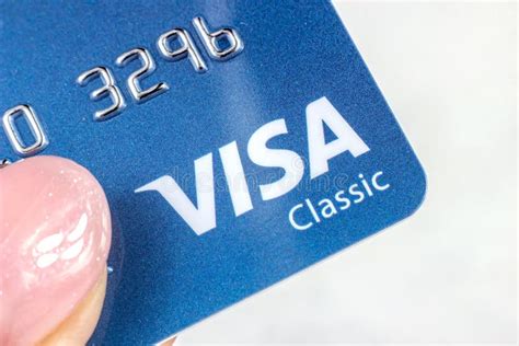 Blue Visa Classic Plastic Card with Logo in Hands on Light Background ...