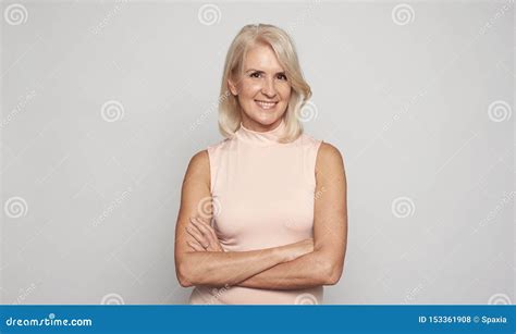 Beautiful 50 Years Lady With Hands Folded Is Smiling Isolated Stock