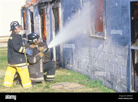 Firemen putting out a house on fire West Virginia Stock Photo - Alamy