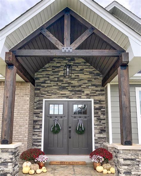 Exposed Truss And Stained Cedar Beams With Double Front Craftsman Doors