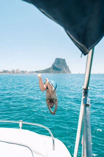 Premium Photo Man Diving Into Water From Boat