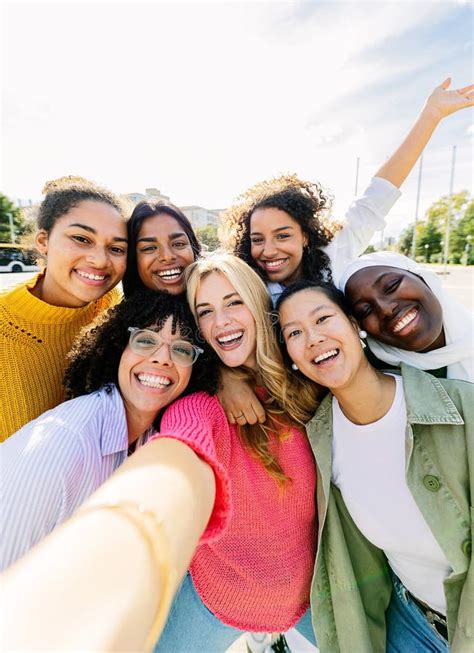 Multiracial Group Of Seven Cheerful Women Having Fun Taking Selfie