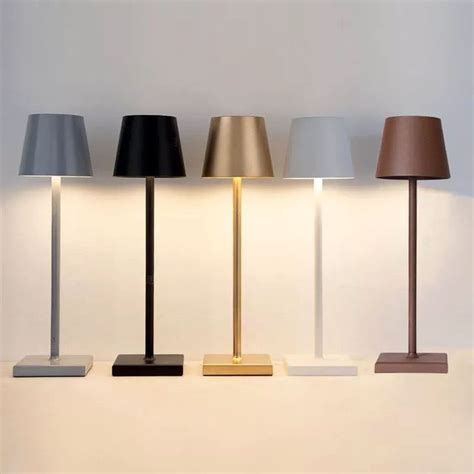 Three Lamps Sitting Next To Each Other On Top Of A White Shelf With Two