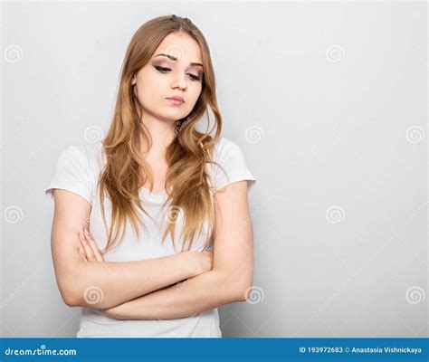 Thinking Blond Unhappy Grimacing Woman Looking Down And Thinking With