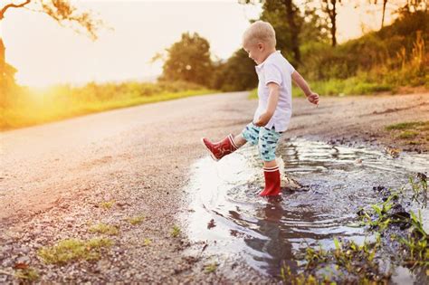 Boy In A Puddle Stock Image Image Of Green Shirt Healthy 50906441