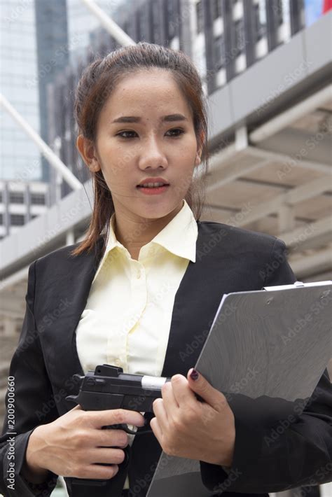 Beautiful women bodyguard and holding gun. Stock Photo | Adobe Stock