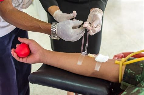 Premium Photo Midsection Of Doctors Taking Blood From Patient In Hospital