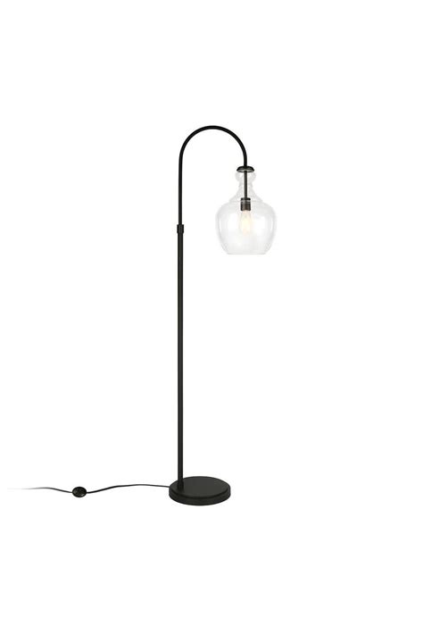 A Lamp That Is Sitting On Top Of A Table Next To A White Wall And Floor