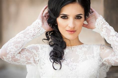 Beautiful Innocent Brunette Bride In White Dress Posing Near Church