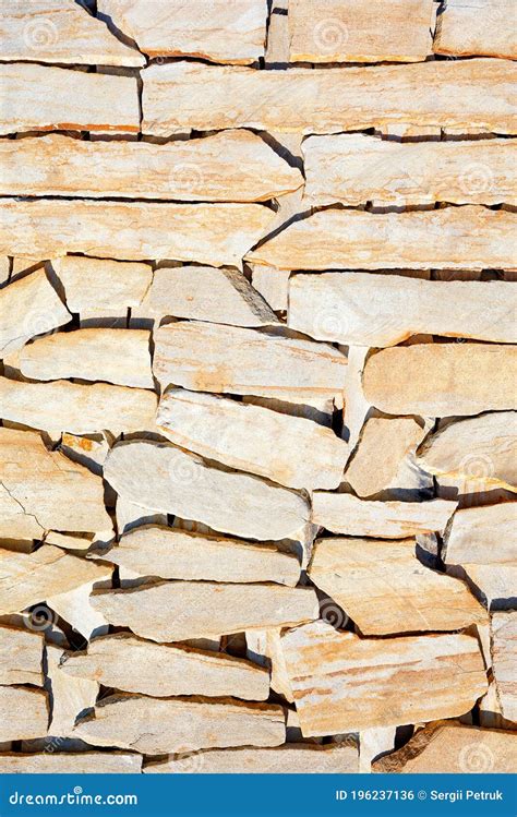 Layered Surface Of Yellow Sandstone Stone With Large Streaks Of Shadow