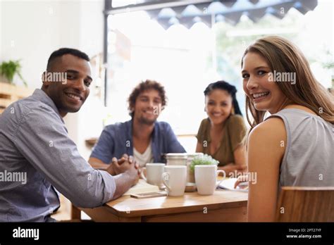 All Together Again A Group Of Friends Talking In A Cafe Stock Photo