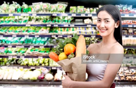 Woman Holding Shopping Paper Bag With Fruit And Vegetables In A