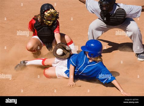 Softball Player Sliding Into Home Plate Stock Photo Alamy