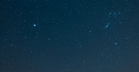 A Starry Night Sky over a Grass Hill · Free Stock Photo