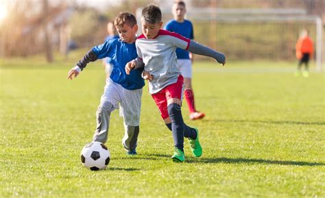 Kids Soccer Football Children Players Match On Soccer Field Stock