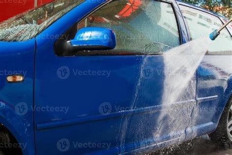 Blue car in a car wash 16290316 Stock Photo at Vecteezy