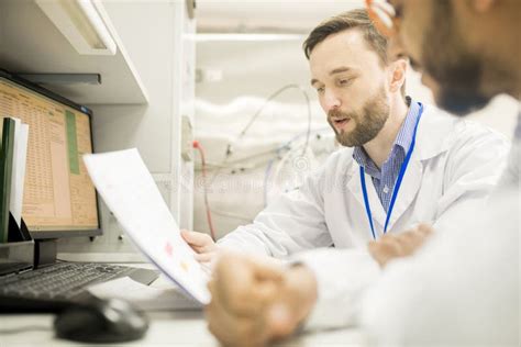 Confident Lab Engineer Explaining Information To Colleague Stock Image